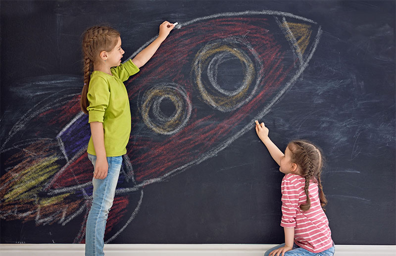children drawing a rocket ship