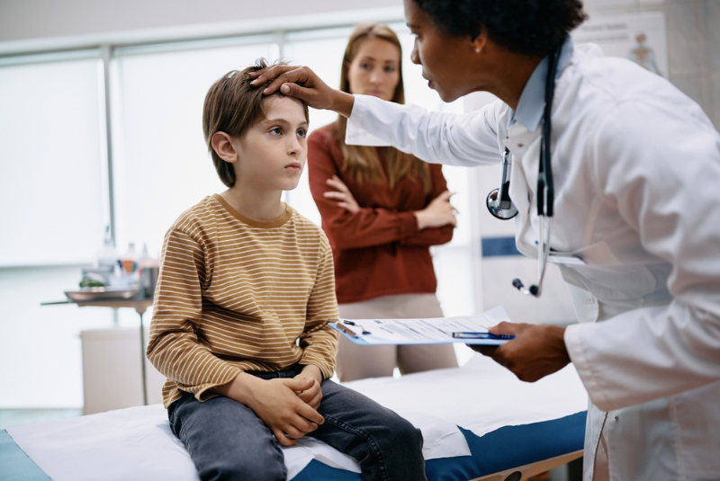 A child is checked for concussion by the doctor
