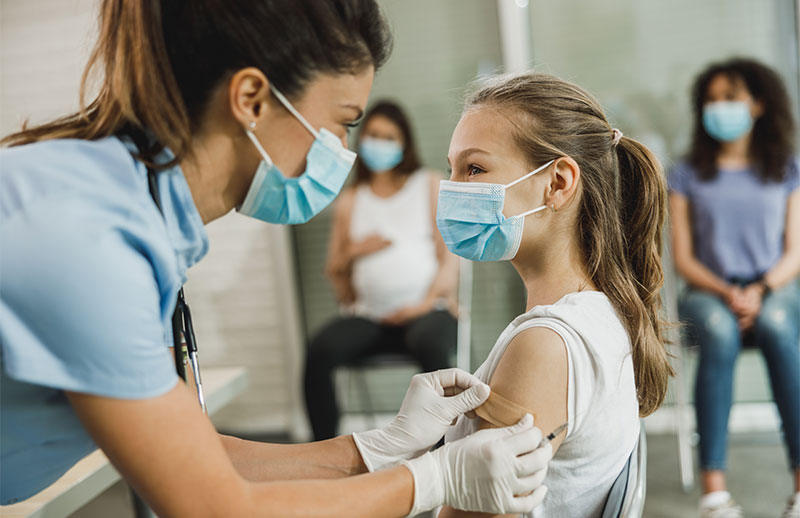 Teen getting vaccination from a nurse