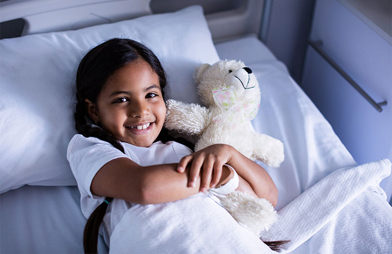 Child in bed smiling