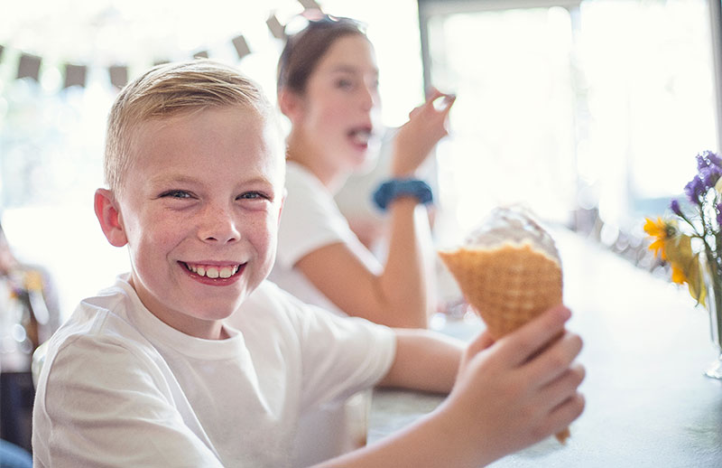 Child eating icecream in a cone
