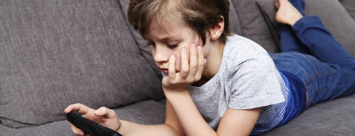 Young person on sofa using a gaming device