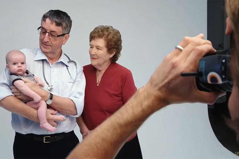 Professor Ruth Bishop and Professor Graeme Barnes holding a baby and having their photo taken