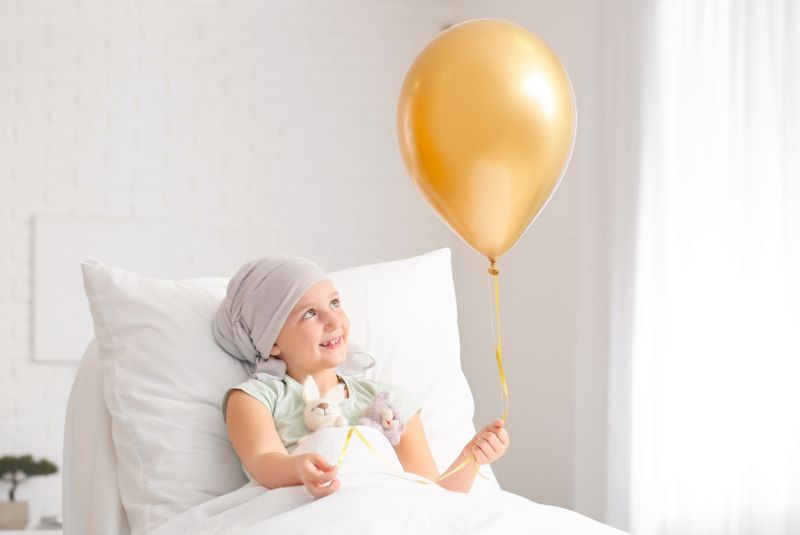 Childhood cancer patient holding balloon