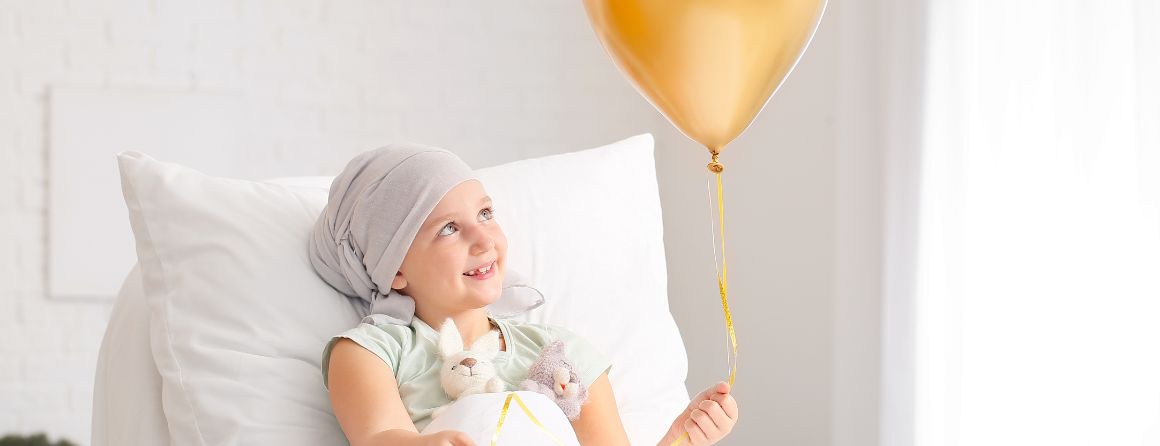 Childhood cancer patient holding balloon