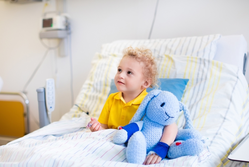 A child receives care in a hospital bed