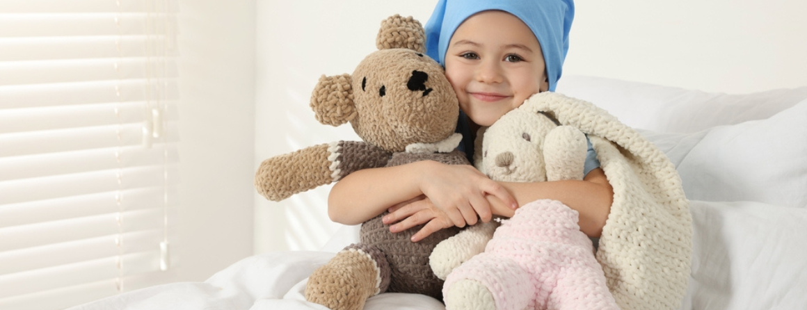 A cancer patient in bed with toys