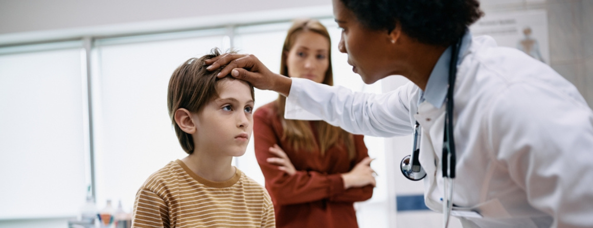 A child is checked for concussion by the doctor