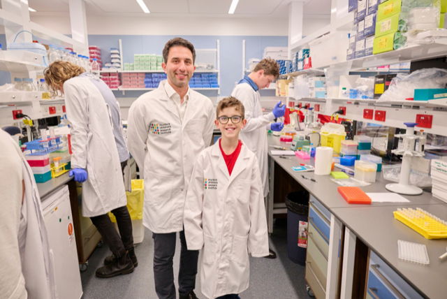Enzo Porrello and child in lab coats