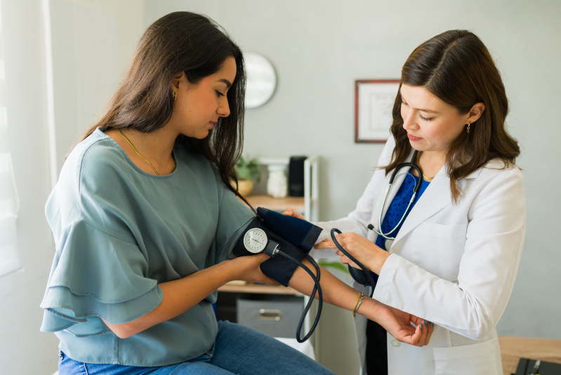 Woman getting blood pressure checked