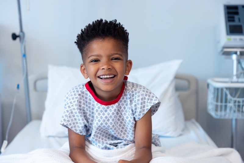 A child smiling in a hospital bed