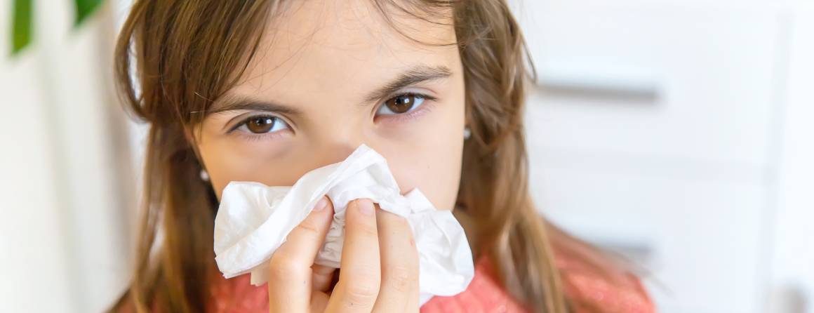 child blowing nose