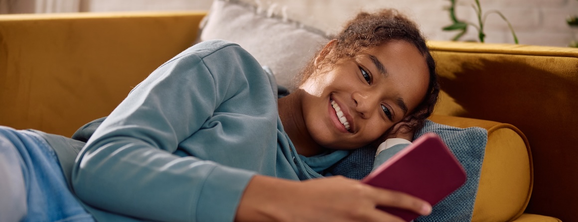 A teenager using social media on their phone