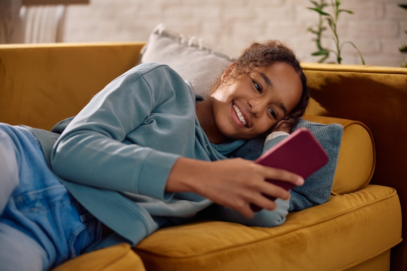 A teenager using social media on their phone