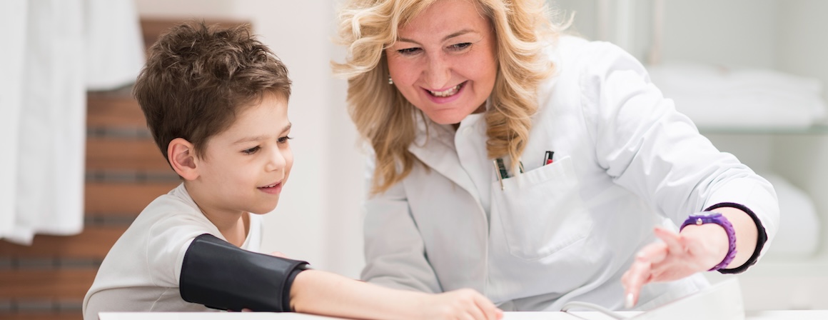 A doctor checking a child's blood pressure