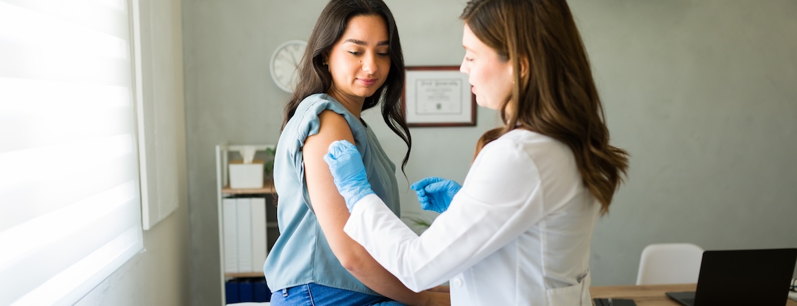 A doctor gives a young girl a covid vaccine