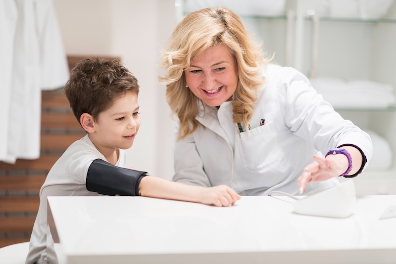A doctor checking a child's blood pressure