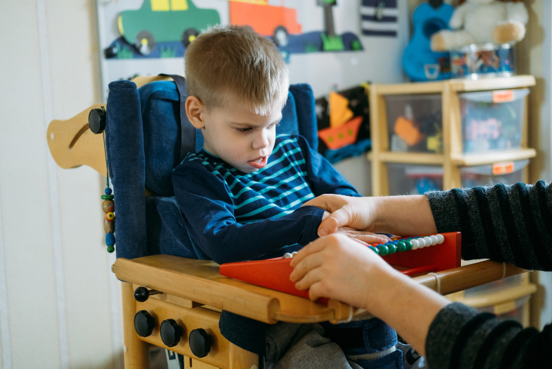 Child with disabilities learning with therapist