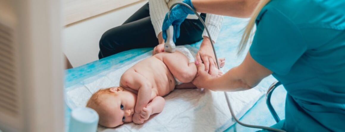 Infant having ultrasound performed on left hip.