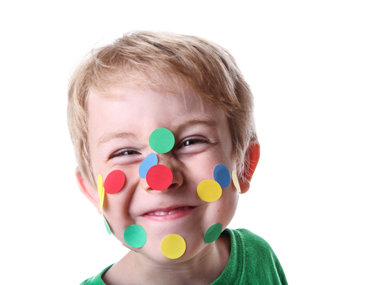 Happy child with colourful stickers on face 