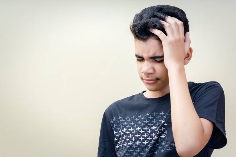 Child holding head
