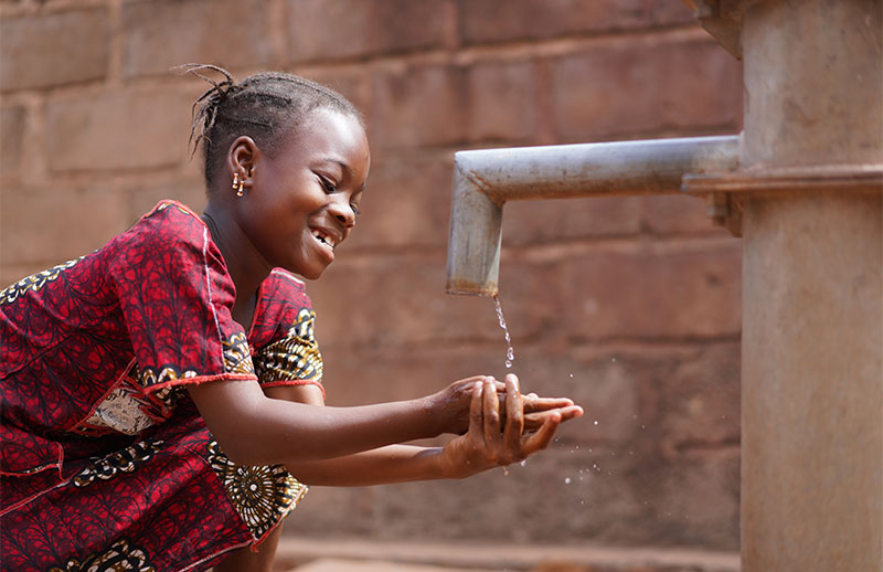 African girl at water tap