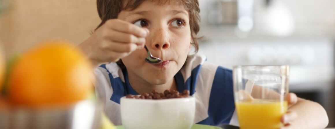 Young boy eating cereal.