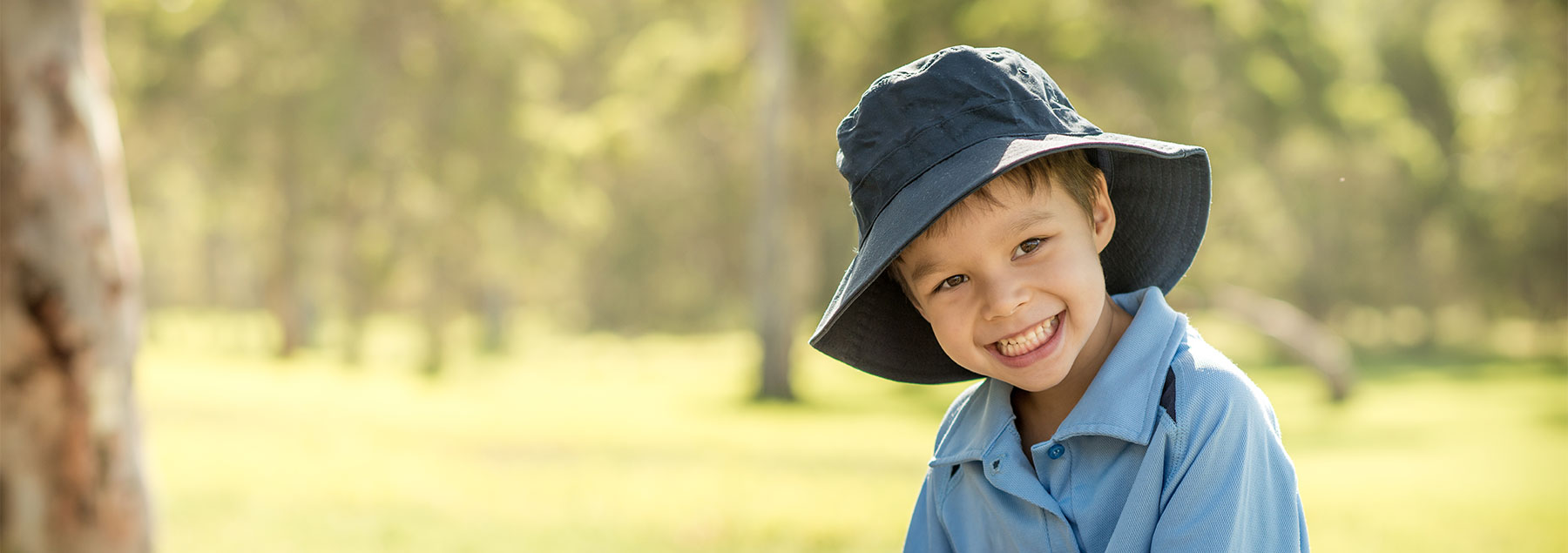 Child in blue hat at the park