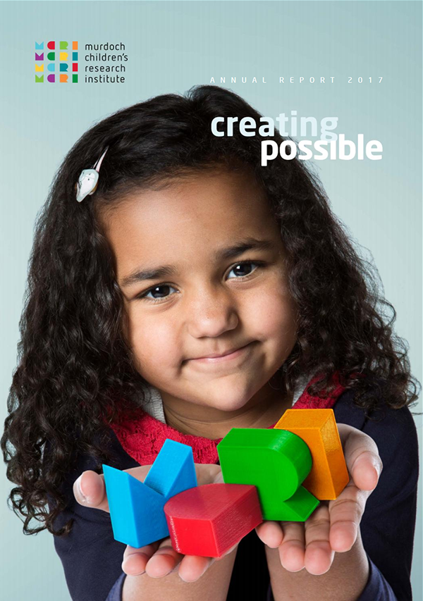 Cover of the 2017 Annual Report featuring a girl holding the letter M-C-R-I