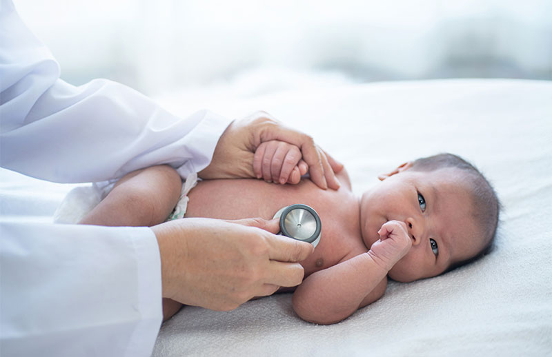 Baby being observed by a doctor