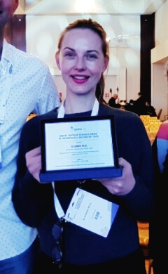 Dr Eleanor Neal holding her Robert Austrian Research Award