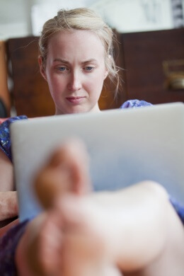 Concerned woman looking at laptop screen