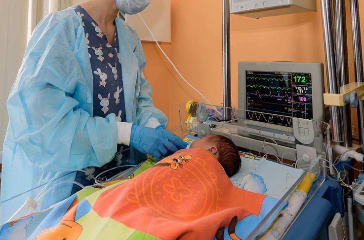 baby being monitored by nurse in hospital