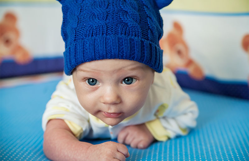 Baby crawling in a beanie