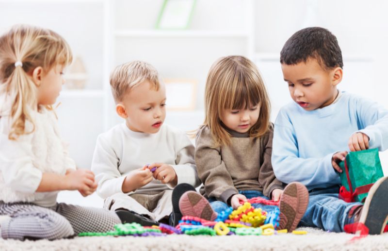 Group of toddlers playing with toys
